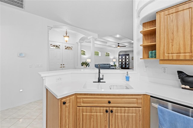 kitchen with open floor plan, stainless steel dishwasher, a sink, visible vents, and a peninsula