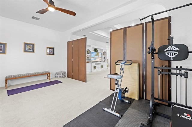 workout room featuring carpet floors, ceiling fan, and visible vents