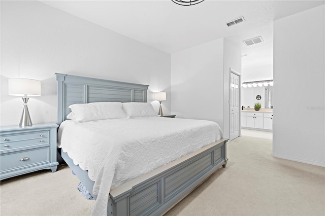 bedroom with connected bathroom, baseboards, light colored carpet, and visible vents