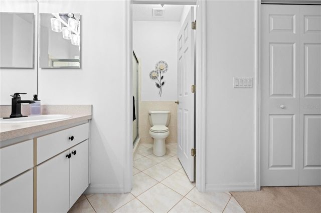 bathroom with visible vents, toilet, tile patterned floors, vanity, and a stall shower
