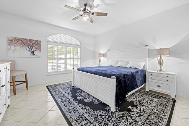 bedroom featuring baseboards, ceiling fan, and light tile patterned floors