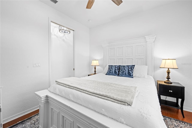 bedroom featuring dark wood-style floors, baseboards, and a ceiling fan