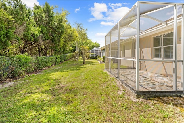view of yard featuring glass enclosure