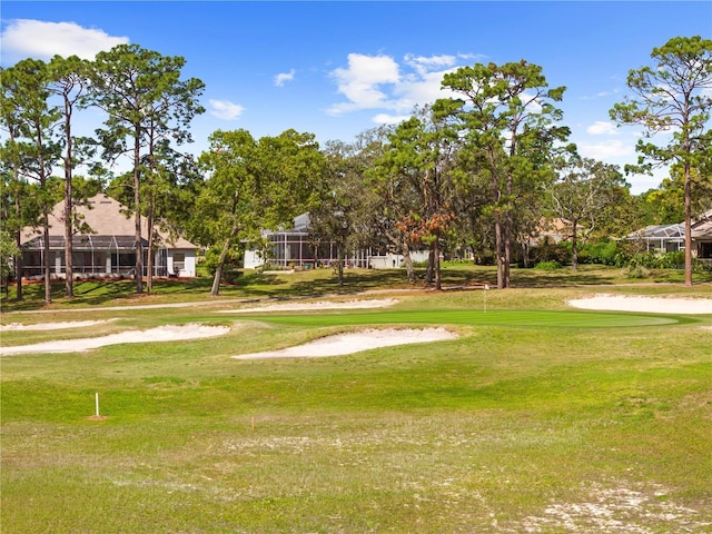 view of property's community with golf course view and a yard