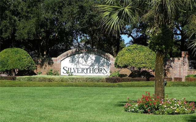 community / neighborhood sign with a lawn