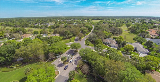 drone / aerial view with a wooded view and a residential view