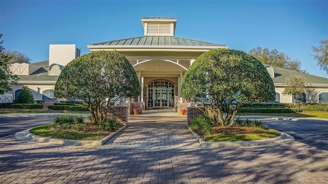 doorway to property with metal roof, a standing seam roof, and french doors