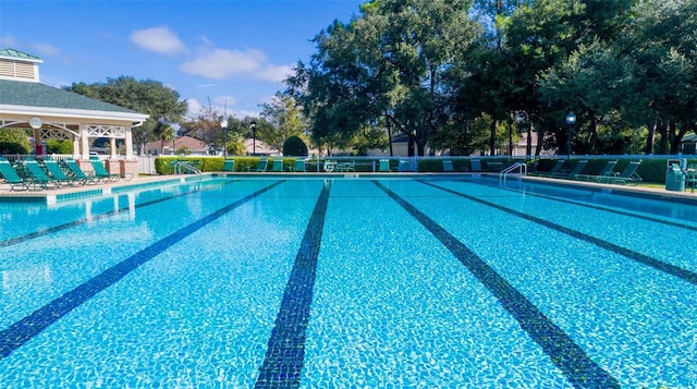 community pool featuring fence and a patio area