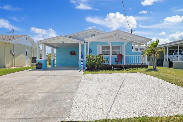 4400 Floramar Ter, New Port Richey, FL 34652 - view of front of property featuring central AC unit, a carport, a porch, a front lawn, and driveway
