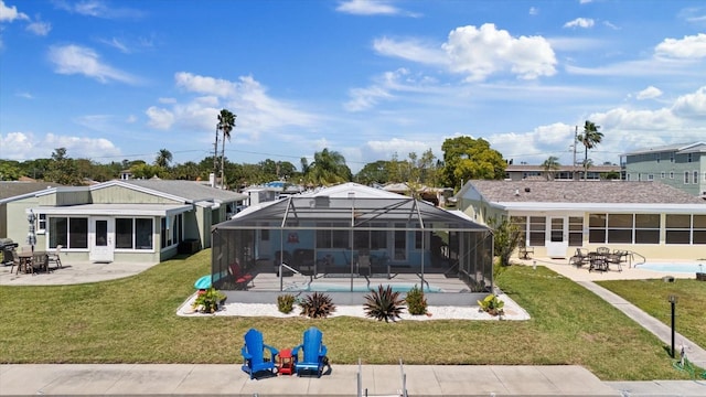 4400 Floramar Ter, New Port Richey, FL 34652 - rear view of property with a patio, an outdoor pool, a yard, and a lanai