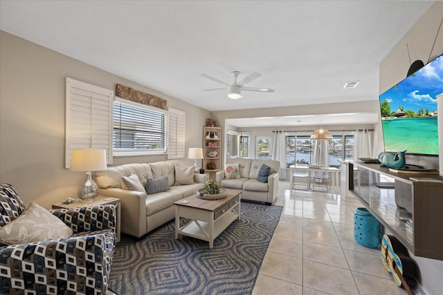 4400 Floramar Ter, New Port Richey, FL 34652 - living area featuring light tile patterned floors, ceiling fan, and visible vents
