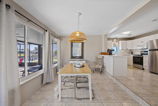 4400 Floramar Ter, New Port Richey, FL 34652 - dining area with light tile patterned flooring
