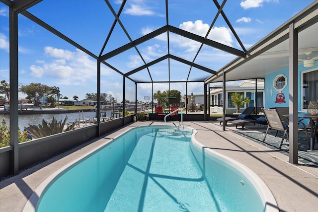 4400 Floramar Ter, New Port Richey, FL 34652 - outdoor pool with a patio area, ceiling fan, glass enclosure, and a water view