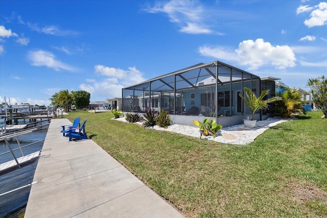 4400 Floramar Ter, New Port Richey, FL 34652 - back of house with a lawn and a lanai