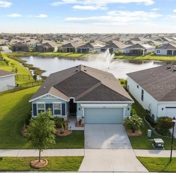 birds eye view of property with a water view and a residential view