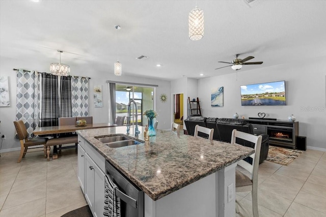 13338 Waterleaf Garden Cir, Riverview, FL 33579 - kitchen featuring a sink, light tile patterned flooring, stone counters, dishwasher, and ceiling fan