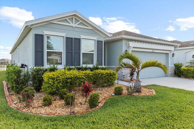 13338 Waterleaf Garden Cir, Riverview, FL 33579 - view of front facade with stucco siding, a garage, a front lawn, and driveway