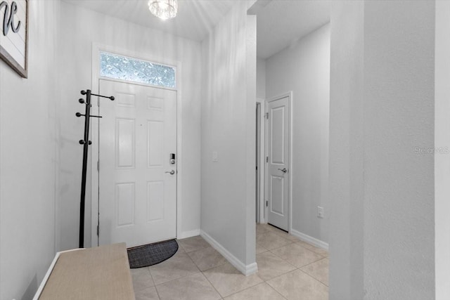 13338 Waterleaf Garden Cir, Riverview, FL 33579 - foyer entrance featuring light tile patterned floors and baseboards