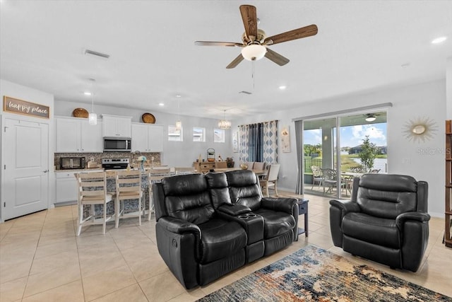 13338 Waterleaf Garden Cir, Riverview, FL 33579 - living room with a ceiling fan, light tile patterned floors, recessed lighting, and a chandelier