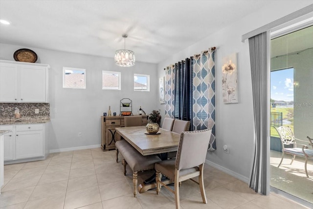 13338 Waterleaf Garden Cir, Riverview, FL 33579 - dining space with a chandelier, light tile patterned floors, and baseboards