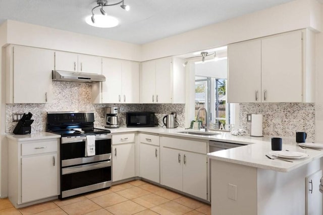 4731 Egret Rd, Venice, FL 34293 - kitchen featuring light countertops, a sink, double oven range, black microwave, and under cabinet range hood
