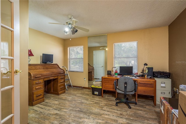 18216 Monteverde Dr, Spring Hill, FL 34610 - home office with a ceiling fan, wood finished floors, and a textured ceiling