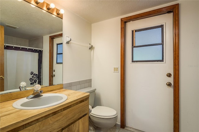 18216 Monteverde Dr, Spring Hill, FL 34610 - bathroom with toilet, a textured ceiling, visible vents, and vanity