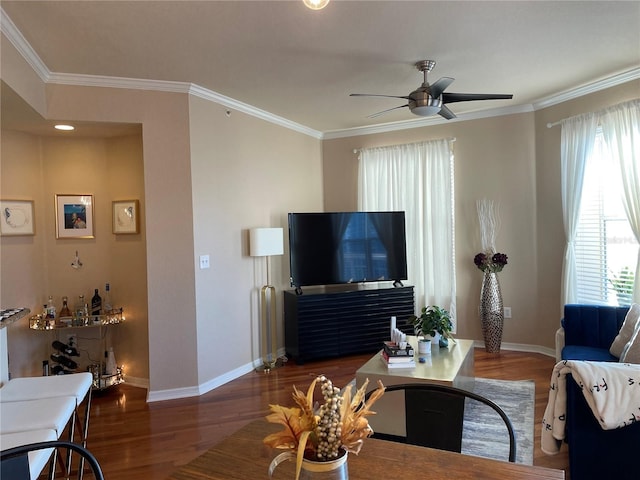 living room with wood finished floors, ceiling fan, baseboards, and ornamental molding