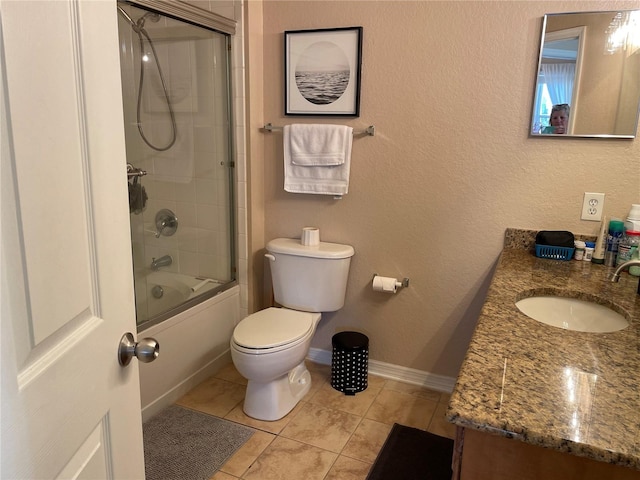 full bathroom with shower / bath combination with glass door, vanity, toilet, tile patterned floors, and baseboards
