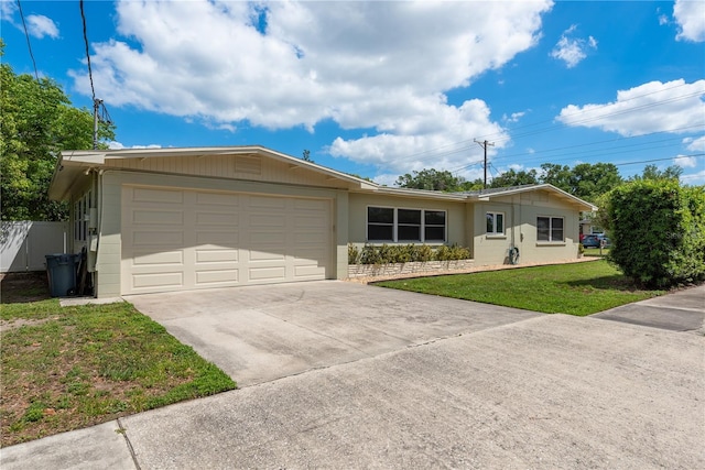 single story home with an attached garage, concrete driveway, fence, and a front lawn