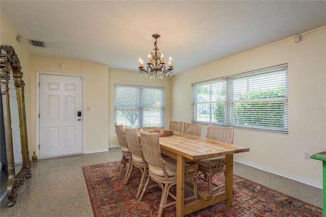 dining room with speckled floor, baseboards, an inviting chandelier, and visible vents