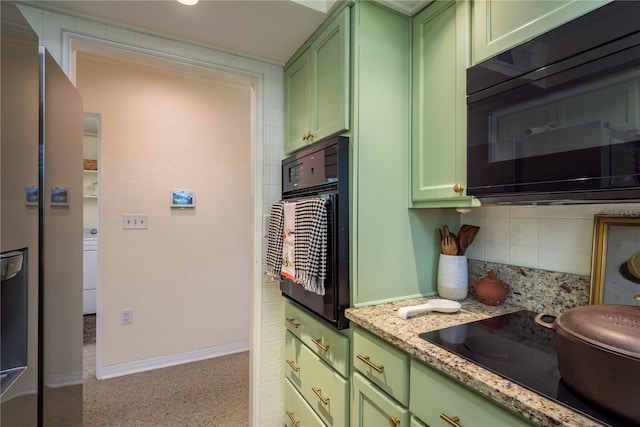 kitchen with green cabinets, baseboards, black appliances, and decorative backsplash