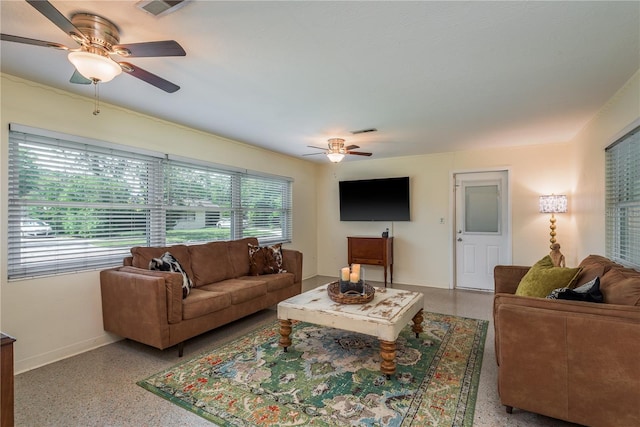 living room with speckled floor, ceiling fan, and visible vents