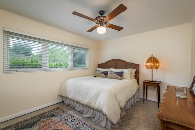 bedroom with speckled floor, baseboards, and ceiling fan