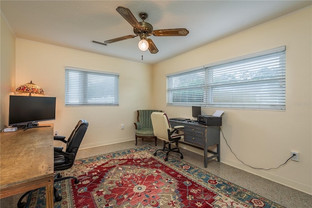 office featuring speckled floor, baseboards, and a ceiling fan