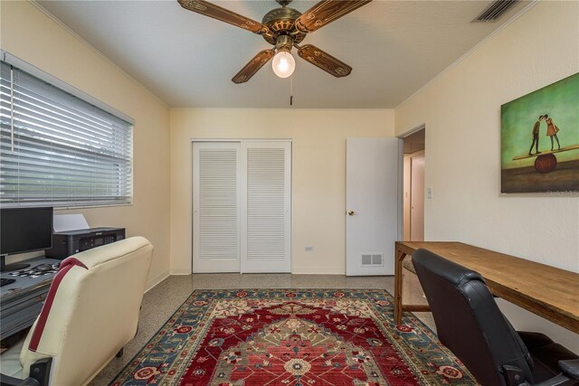 home office with visible vents, baseboards, a ceiling fan, and speckled floor