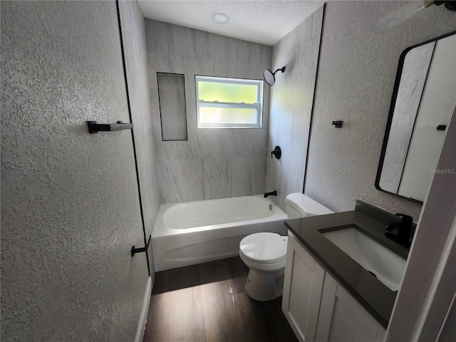 825 Lincoln Ave, Tarpon Springs, FL 34689 - full bath with toilet, shower / bathing tub combination, wood finished floors, a textured wall, and vanity