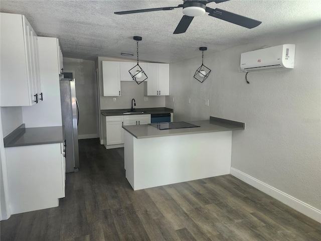 825 Lincoln Ave, Tarpon Springs, FL 34689 - kitchen with a sink, dark countertops, freestanding refrigerator, black electric stovetop, and a wall mounted AC