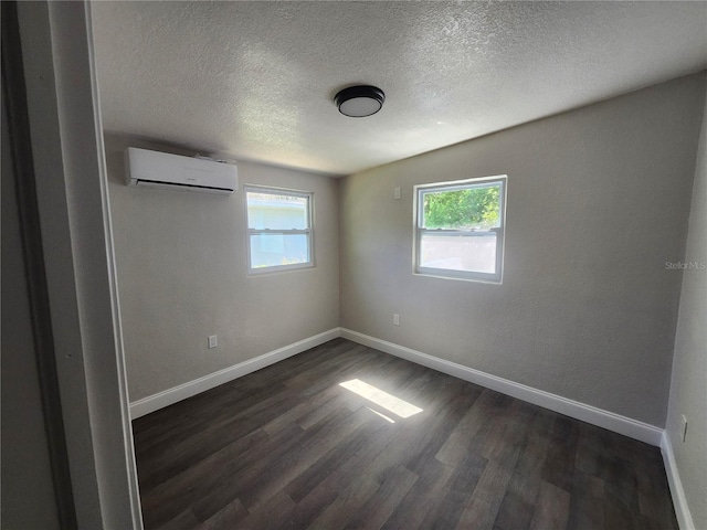 825 Lincoln Ave, Tarpon Springs, FL 34689 - unfurnished room featuring dark wood-type flooring, a wall mounted air conditioner, a healthy amount of sunlight, and baseboards