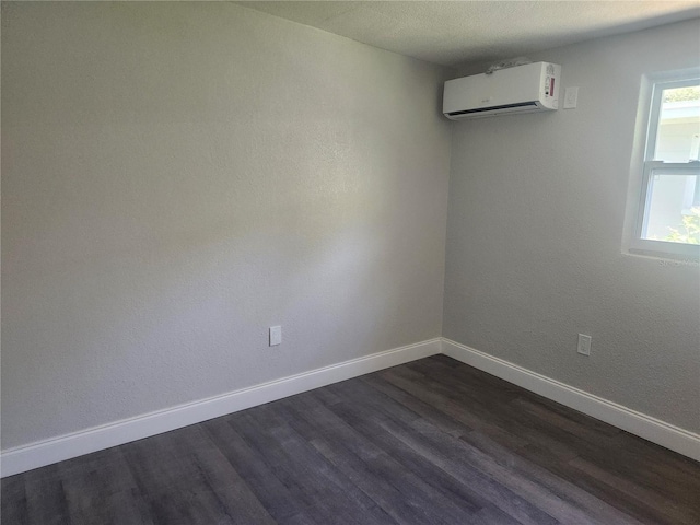 825 Lincoln Ave, Tarpon Springs, FL 34689 - spare room featuring baseboards, a wall unit AC, and dark wood-style flooring