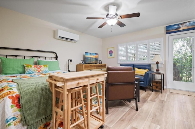 bedroom with ceiling fan, light wood-type flooring, and a wall mounted AC