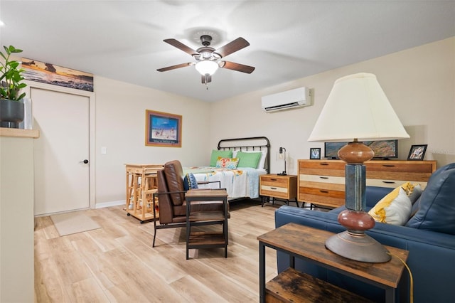 bedroom featuring light wood-type flooring and a wall unit AC