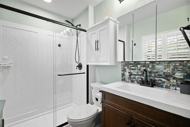 bathroom with tasteful backsplash, toilet, a shower stall, and vanity