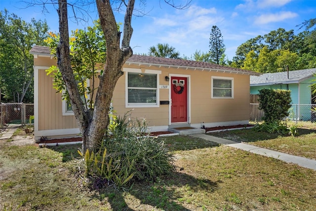 1309 45th St S, Saint Petersburg, FL 33711 - view of front of home with fence and a front lawn