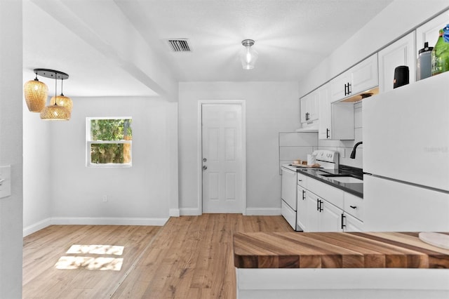1309 45th St S, Saint Petersburg, FL 33711 - kitchen featuring visible vents, white cabinets, a sink, dark countertops, and white appliances