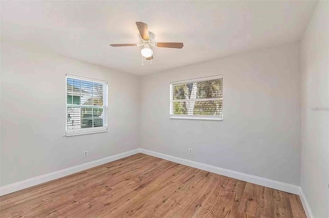 1309 45th St S, Saint Petersburg, FL 33711 - empty room featuring a wealth of natural light, light wood-style floors, ceiling fan, and baseboards