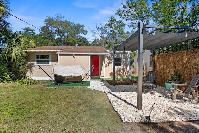 1309 45th St S, Saint Petersburg, FL 33711 - rear view of property with a pergola, a yard, and fence
