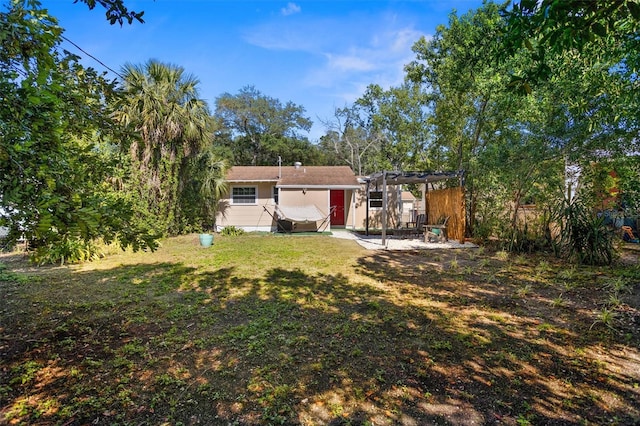 1309 45th St S, Saint Petersburg, FL 33711 - back of property with a pergola, a patio, and a lawn