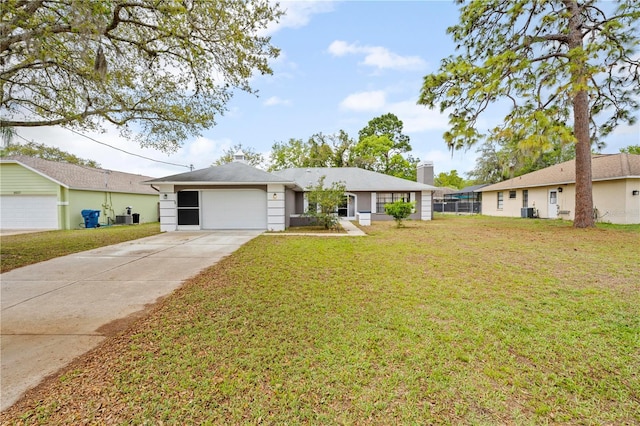 ranch-style home featuring central air condition unit, concrete driveway, a front yard, and a garage