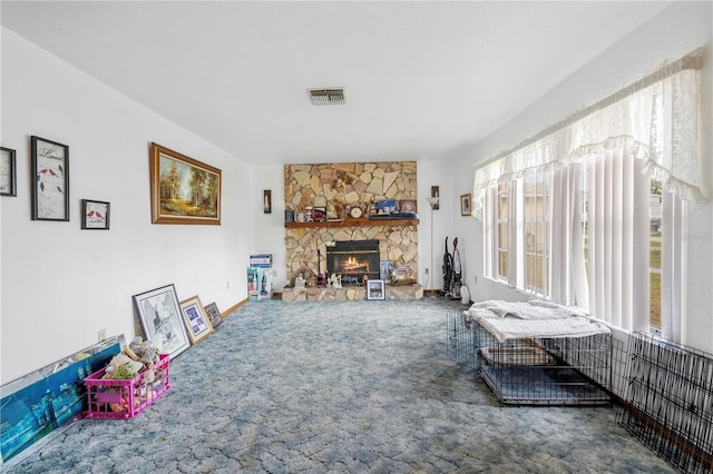 living area featuring a fireplace, visible vents, and carpet floors